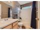 Functional bathroom with a shower-tub combination, vanity sink, and tiled walls for easy maintenance at 9651 Bighorn Way, Littleton, CO 80125