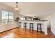 Open concept dining area with hardwood floors and breakfast bar at 9651 Bighorn Way, Littleton, CO 80125