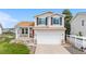 Charming two-story home featuring a well-manicured lawn and inviting front porch at 9651 Bighorn Way, Littleton, CO 80125
