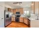 Functional kitchen with stainless steel appliances and ample cabinet space at 9651 Bighorn Way, Littleton, CO 80125