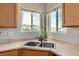Kitchen sink and countertops with a mountain view from the windows at 9651 Bighorn Way, Littleton, CO 80125