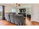 Cozy living room featuring hardwood floors, a comfortable sofa and TV at 9651 Bighorn Way, Littleton, CO 80125