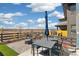 Inviting backyard patio with stylish outdoor furniture, fire pit, and views of the surrounding landscape at 1526 Golden Sill Dr, Castle Pines, CO 80108