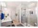 Modern bathroom featuring double sinks, large shower with glass doors, and neutral tile flooring at 1526 Golden Sill Dr, Castle Pines, CO 80108