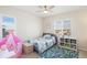 Bright bedroom with a window with shutters, a bed, and play tent at 1526 Golden Sill Dr, Castle Pines, CO 80108