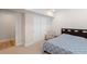 Bright bedroom featuring a large closet, comfortable chair, and a stylish blue patterned bedspread at 1526 Golden Sill Dr, Castle Pines, CO 80108