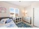 Cozy bedroom featuring plantation shutters, a bookshelf, and a dresser at 1526 Golden Sill Dr, Castle Pines, CO 80108