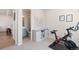 Exercise room featuring a stationary bike, world map art, storage cabinet, and doorway to the adjacent bathroom at 1526 Golden Sill Dr, Castle Pines, CO 80108