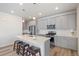 Well-lit kitchen with stainless steel appliances, a large island, and a breakfast bar with stools at 1526 Golden Sill Dr, Castle Pines, CO 80108