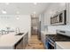 Modern kitchen featuring stainless appliances, a large island, and lots of natural light at 1526 Golden Sill Dr, Castle Pines, CO 80108