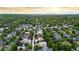 Aerial view showing the neighborhood, mature trees, and Denver skyline in the distance at 7444 E 9Th Ave, Denver, CO 80230