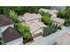 Aerial view showcasing the home's tile roof, manicured landscaping, and two-car garage at 7444 E 9Th Ave, Denver, CO 80230