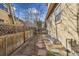 Private backyard with wood fencing, a small deck and stone paver walkway at 7444 E 9Th Ave, Denver, CO 80230