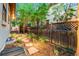 Backyard with landscaping and pathway lighting, and a privacy fence, enhancing the home's outdoor space at 7444 E 9Th Ave, Denver, CO 80230
