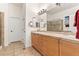 Bathroom featuring dual sinks, a vanity with plenty of drawers and doors, and a glass shower at 7444 E 9Th Ave, Denver, CO 80230