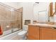 Bathroom with a glass shower, standard toilet, and sink with a vanity, all in neutral colors at 7444 E 9Th Ave, Denver, CO 80230