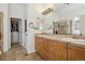 A bathroom with double sinks, a walk-in shower, and a closet at 7444 E 9Th Ave, Denver, CO 80230