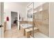 Bathroom with a glass shower, a soaking tub, and steps leading up to both for easy access at 7444 E 9Th Ave, Denver, CO 80230