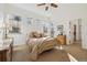 A bedroom with natural light from windows, a ceiling fan, and a door leading to the exterior at 7444 E 9Th Ave, Denver, CO 80230