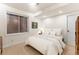 Cozy bedroom with a double bed, window with blinds, and a wardrobe at 7444 E 9Th Ave, Denver, CO 80230