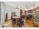 Bright dining area leading to a kitchen featuring dark wood cabinets, and stainless steel appliances at 7444 E 9Th Ave, Denver, CO 80230