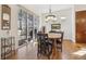 Bright dining area with large sliding doors, hardwood floors, and an elegant light fixture above the table at 7444 E 9Th Ave, Denver, CO 80230