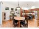 The dining area showcases hardwood floors, a chandelier, and seamless access to the adjacent kitchen area at 7444 E 9Th Ave, Denver, CO 80230