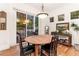 Dining room with an outdoor view, a wooden dining table, a chandelier, and hardwood flooring at 7444 E 9Th Ave, Denver, CO 80230