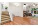 Inviting foyer features hardwood floors, a staircase leading upstairs, and ample natural light from nearby windows at 7444 E 9Th Ave, Denver, CO 80230