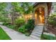 Inviting front entrance with well-maintained landscaping and a cozy front porch at 7444 E 9Th Ave, Denver, CO 80230