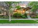 Charming stucco home featuring manicured landscaping, covered entryway, and inviting curb appeal at 7444 E 9Th Ave, Denver, CO 80230