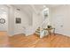Hallway with a staircase, hardwood floors, neutral paint, and tasteful decor contribute to an inviting ambiance at 7444 E 9Th Ave, Denver, CO 80230