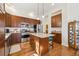 A kitchen with stainless steel appliances, wood cabinets, and an island at 7444 E 9Th Ave, Denver, CO 80230