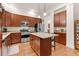 Kitchen with stainless steel appliances, a center island, pendant lighting, hardwood flooring and ample cabinet space at 7444 E 9Th Ave, Denver, CO 80230