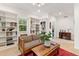 Living room featuring a sitting area with bookshelves and a desk area adjacent to a large window at 7444 E 9Th Ave, Denver, CO 80230