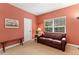 Cozy living room with a leather sofa, bench, side table, and a bright window at 7444 E 9Th Ave, Denver, CO 80230