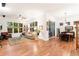 Bright, open living room with hardwood floors, a ceiling fan, large windows, and a sliding glass door to the outside at 7444 E 9Th Ave, Denver, CO 80230