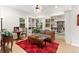 Living room with custom built-in bookshelves, a patterned couch, a coffee table, and a checkered rug at 7444 E 9Th Ave, Denver, CO 80230