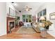 Bright living room boasts a fireplace, plush rug, ceiling fan, and large windows offering natural light at 7444 E 9Th Ave, Denver, CO 80230