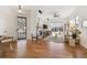 Bright living room features a fireplace, hardwood floors, a ceiling fan, and large windows offering natural light at 7444 E 9Th Ave, Denver, CO 80230