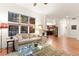 Spacious living room with hardwood floors, fireplace, large windows, and plush seating at 7444 E 9Th Ave, Denver, CO 80230