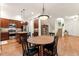 Kitchen and dining area with stainless steel appliances, a center island and a staircase to the upper level at 7444 E 9Th Ave, Denver, CO 80230