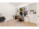 Office space with a built-in desk, shelves, storage drawers, and a window providing natural light at 7444 E 9Th Ave, Denver, CO 80230