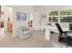 Bright office space with a work area, comfortable chair and views of a bathroom and another room at 7444 E 9Th Ave, Denver, CO 80230