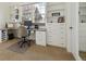 A home office with a built-in desk, shelves, and natural light at 7444 E 9Th Ave, Denver, CO 80230