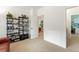 Room featuring a bookshelf with decorations and an open doorway at 7444 E 9Th Ave, Denver, CO 80230