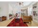 A sitting room with built-in bookshelves, a table, and a red rug at 7444 E 9Th Ave, Denver, CO 80230