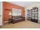 Cozy sitting room with a comfortable leather sofa and decorative shelving at 7444 E 9Th Ave, Denver, CO 80230