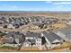 An aerial view showcasing the well-planned community with landscaped streets and stunning mountain views at 1180 Ascent Trail Cir, Erie, CO 80516