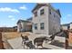 Back of house features a patio with chairs overlooking the yard and new construction at 1180 Ascent Trail Cir, Erie, CO 80516